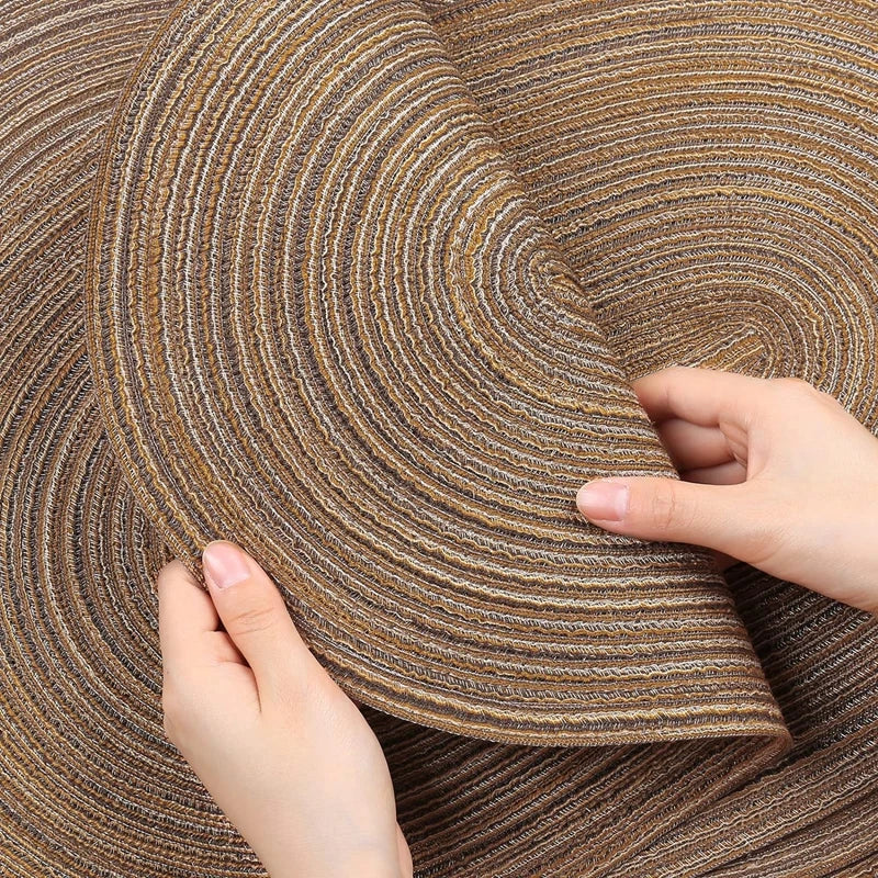 Hands holding elegant Oval Braided Placemats in natural tones for dining decor