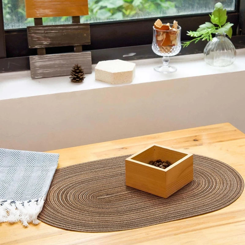 Oval Braided Placemats in Brown on a Dining Table with Natural Decor Elements