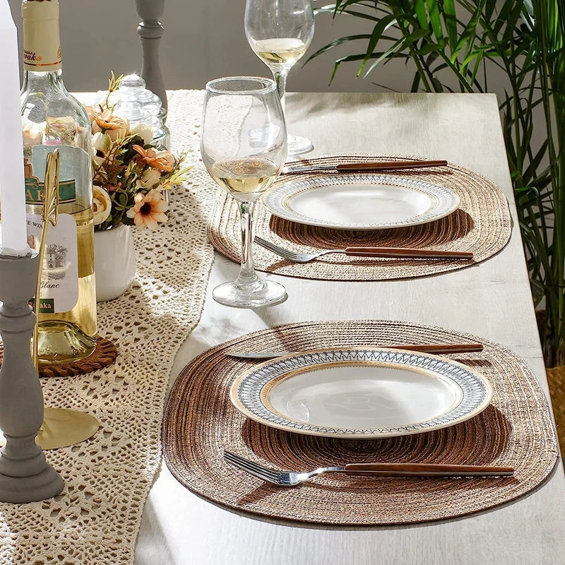 Elegant dining setup featuring Oval Braided Placemats with matching plates and wine glasses