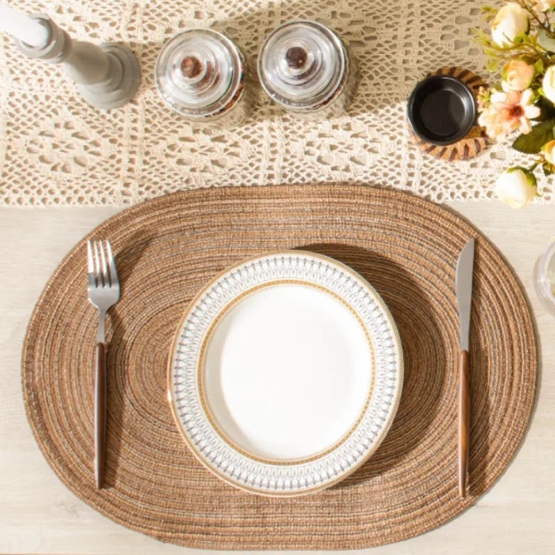 Oval Braided Placemats in Natural Fiber Setting with Elegant Tableware and Decor