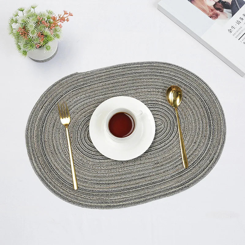 Stylish oval braided placemats in grey designed for elegant dining settings