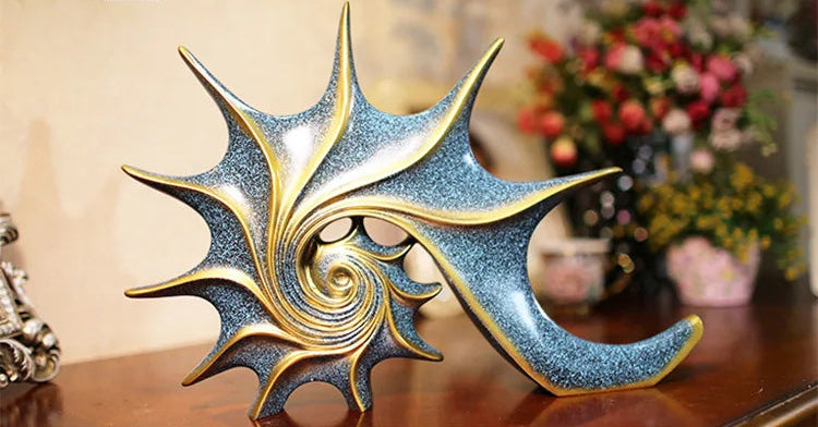 Nutshell resin conch Nordic statue decor with gold and blue spiral design on wooden surface
