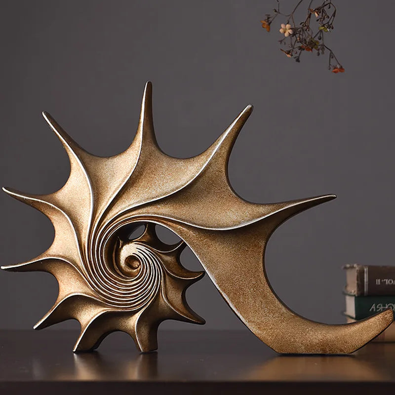 Nutshell resin conch Nordic statue decor in gold finish with spiral design on wooden surface