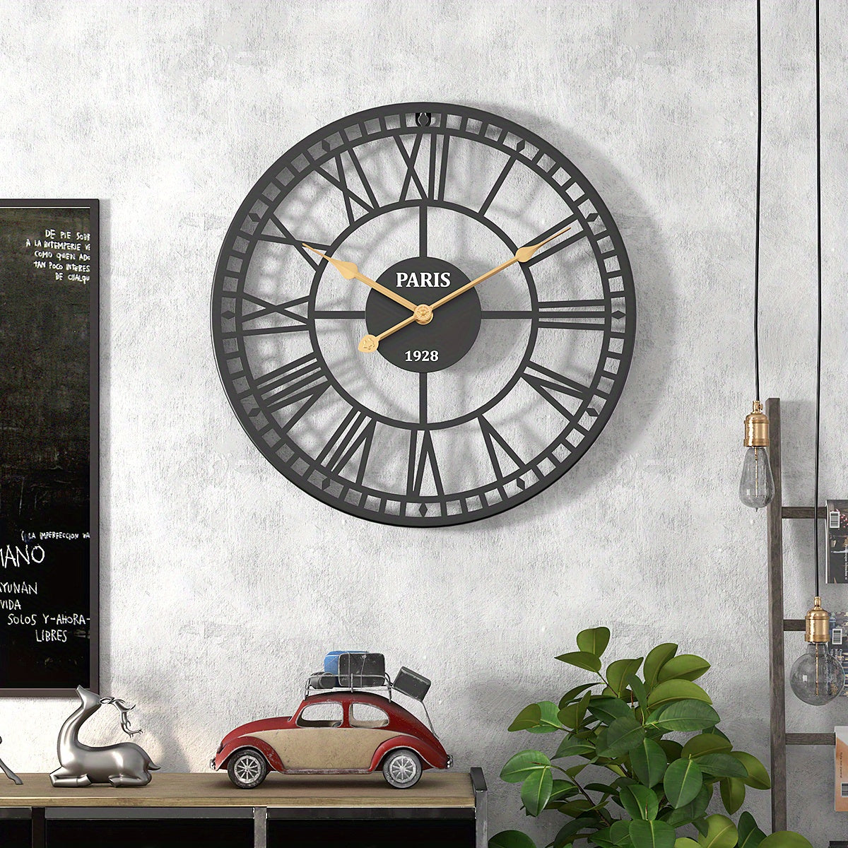Nutshell Roman numeral wall clock with a black metal frame and gold accents for home decor