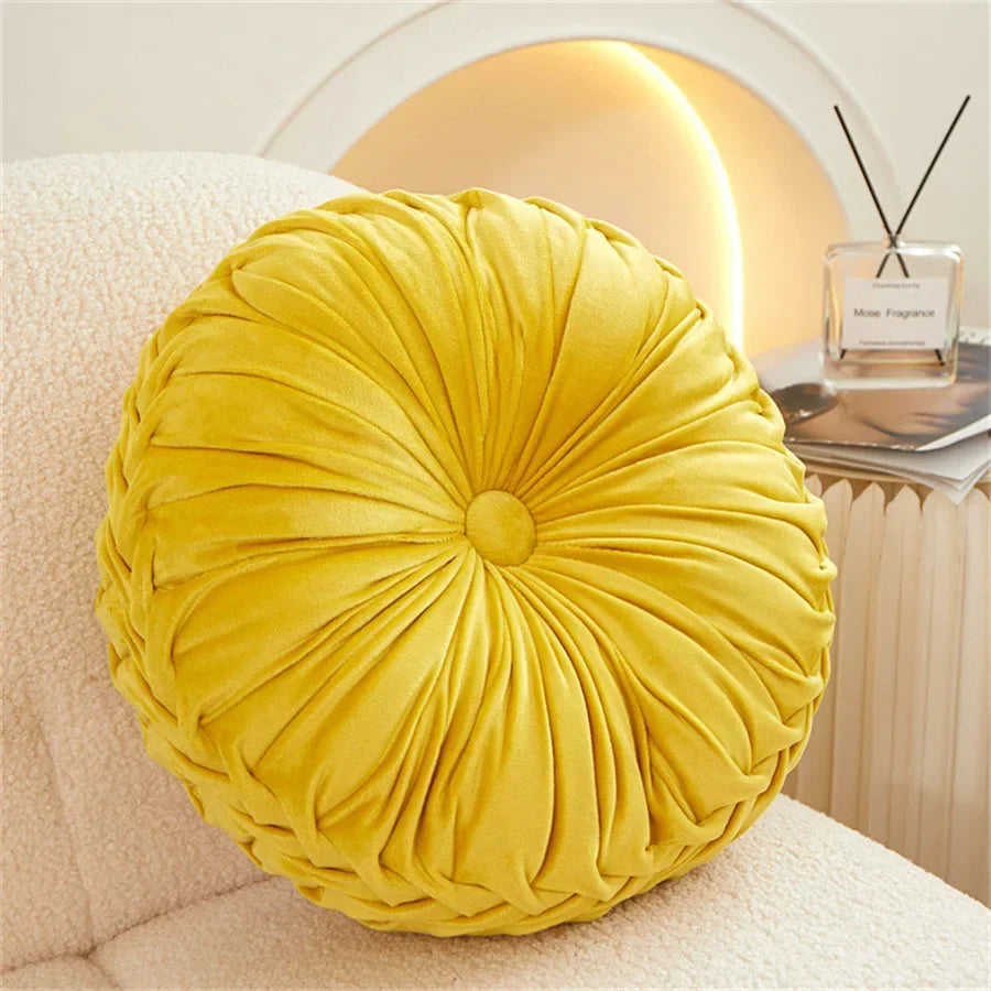 Nutshell yellow round pumpkin pillow cushion with soft pleated fabric on a white chair