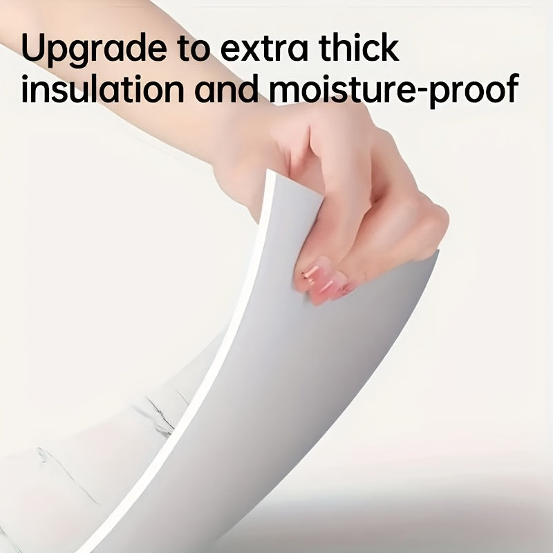 Close-up of a hand demonstrating self-adhesive decorative tiles with extra thick insulation and moisture-proof features