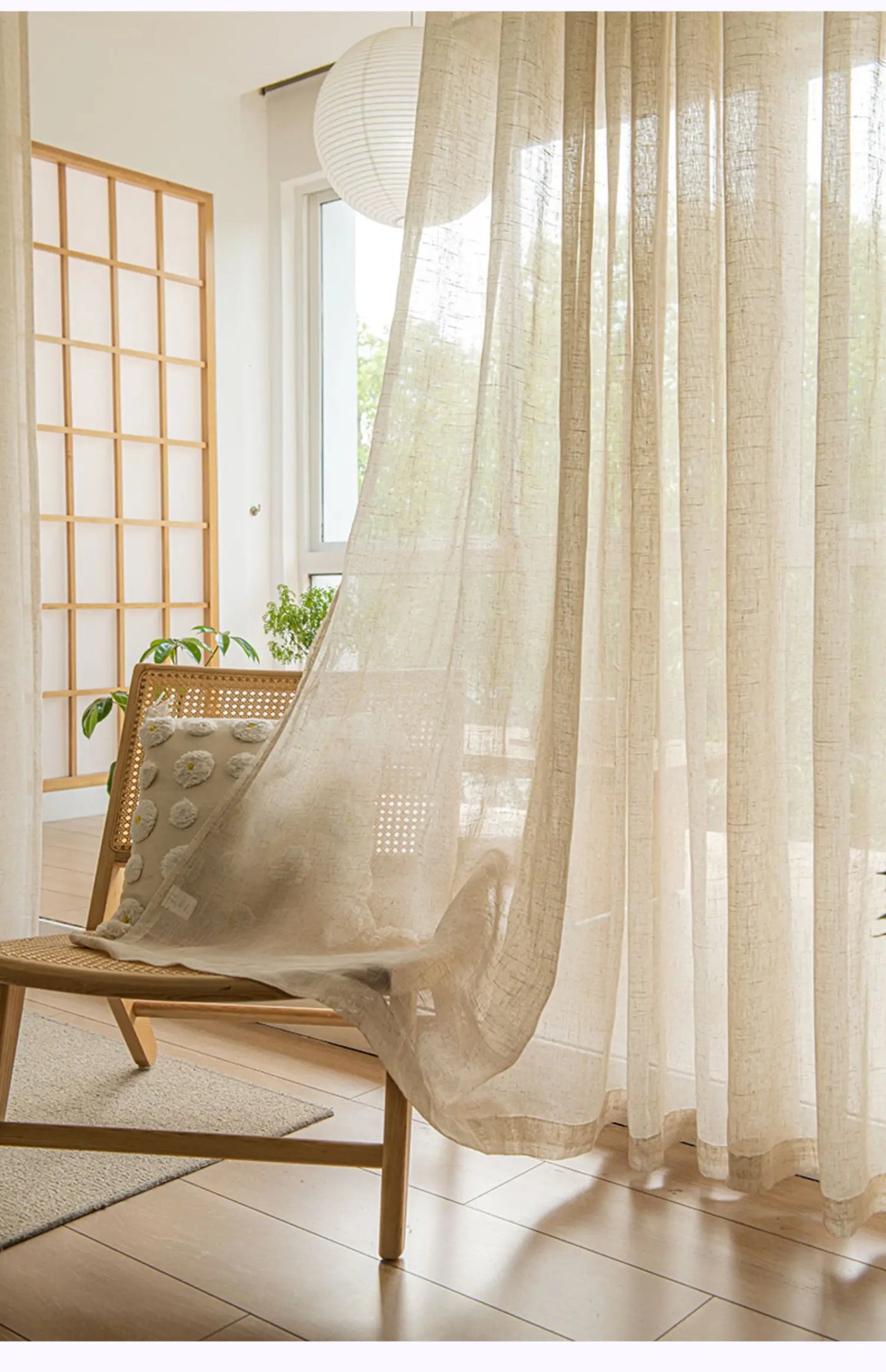 Nutshell Cotton Linen Beige Sheer Curtains billowing in sunlit room over wooden chair with rattan cushion