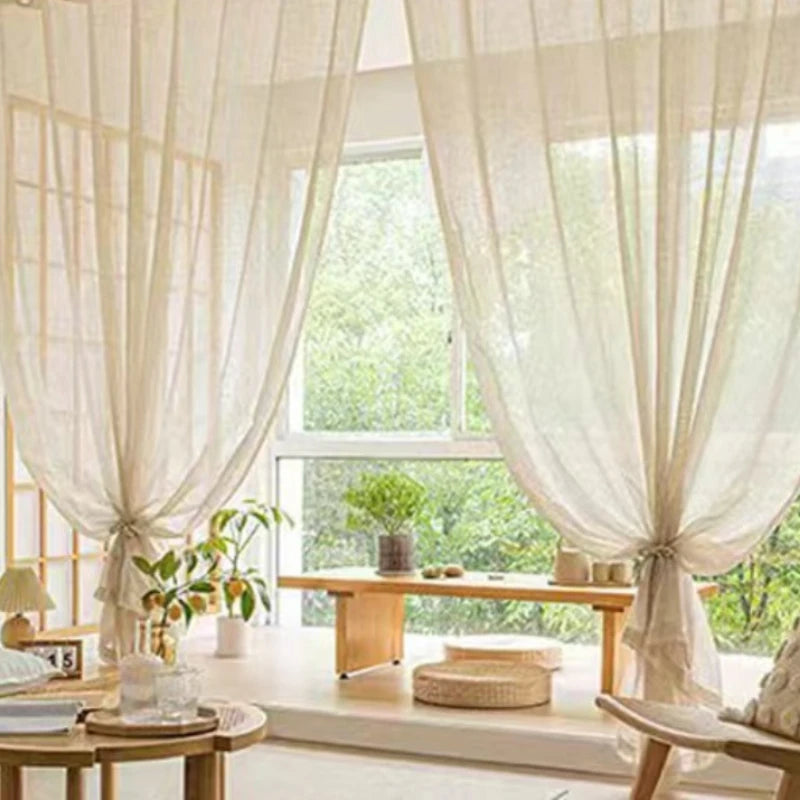 Nutshell Cotton Linen Beige Sheer Curtains draped over a sunny window seat tied back to filter soft natural light