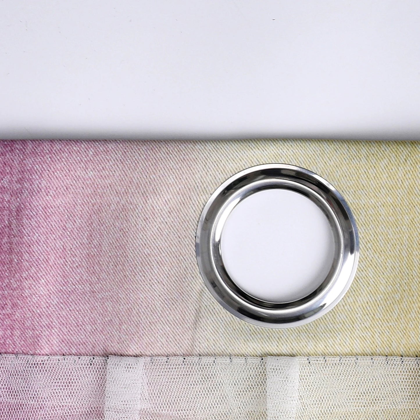 Nutshell Colorful Rainbow Twinkle Star Curtains close up showing silver grommet and pastel gradient sheer fabric