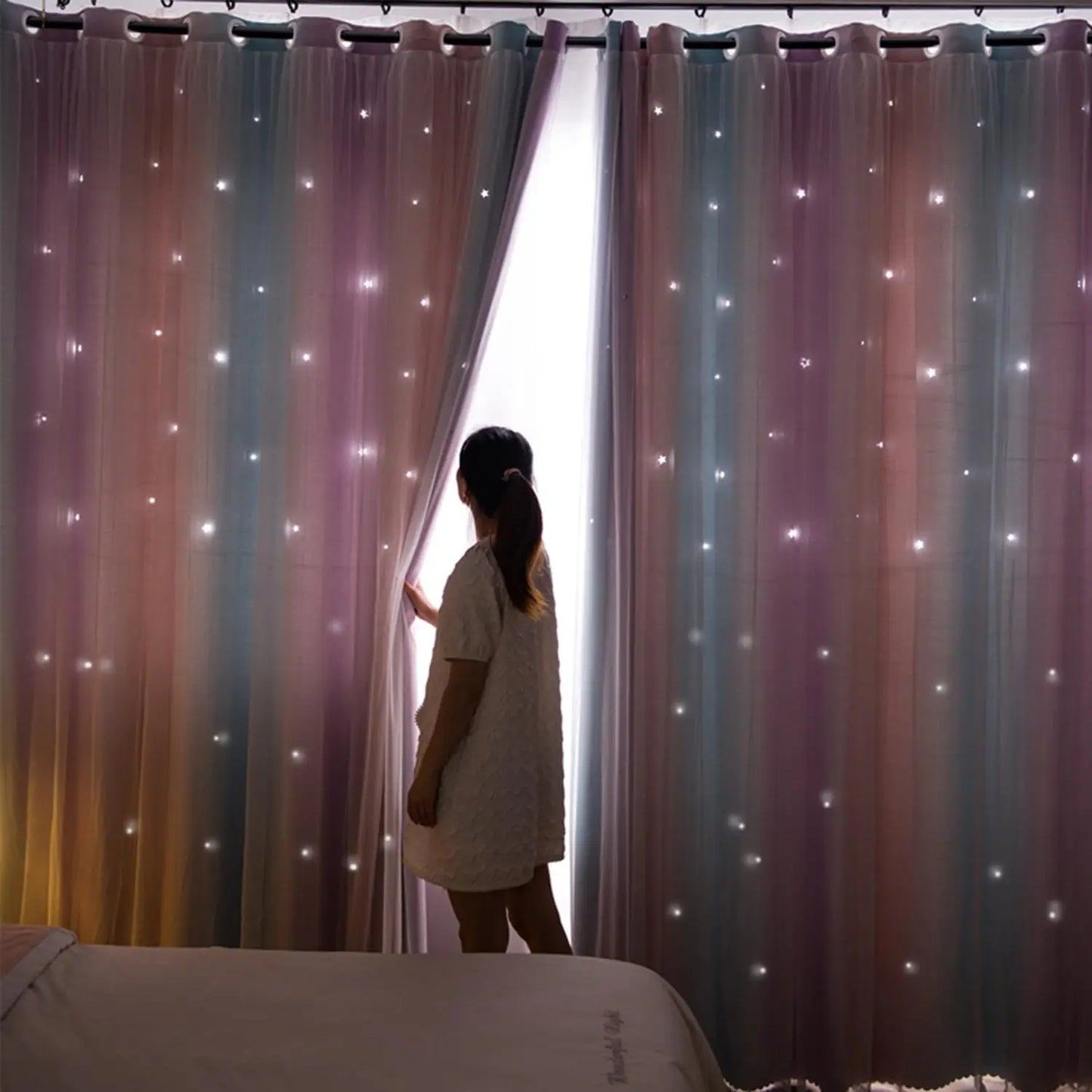 Nutshell Colorful Rainbow Twinkle Star Curtains hung with grommets in bedroom showing soft twinkle lights and blackout backing
