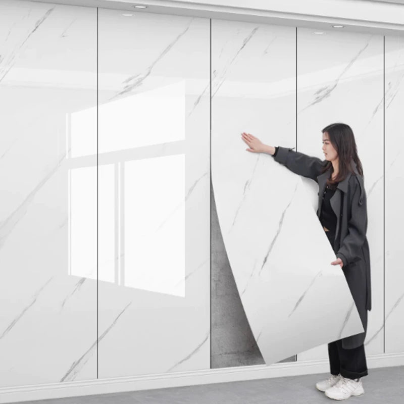 Nutshell wall paper marble peel and stick panels being applied by a woman mimicking imitation ceramic tile finish