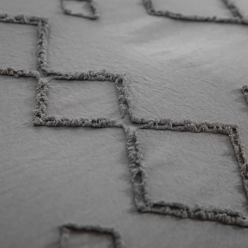 Close-up of Nutshell tufted gray duvet cover set featuring textured square patterns on soft fabric