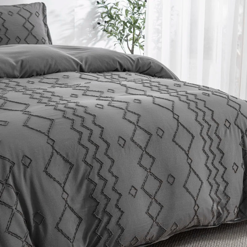 Nutshell tufted gray duvet cover set with geometric stitched pattern on a bed in a bright room