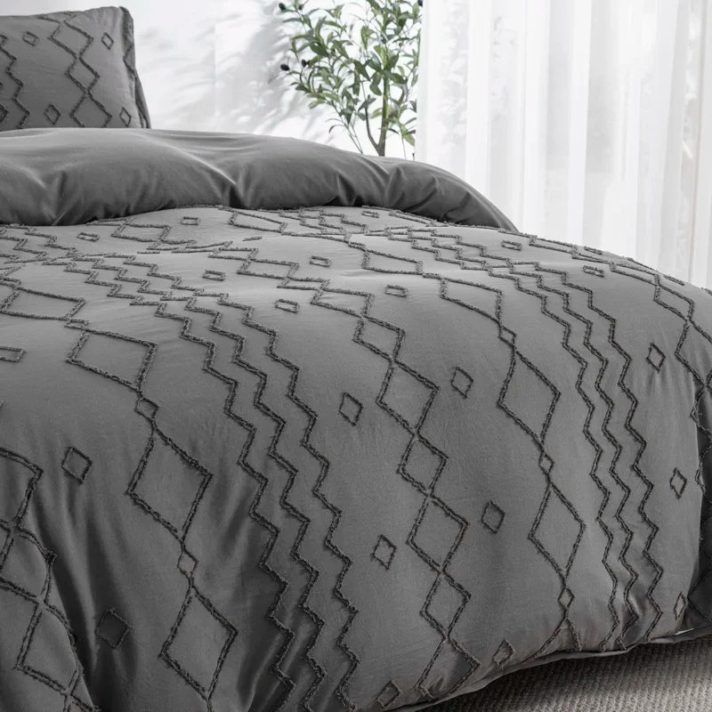 Nutshell tufted gray duvet cover set with geometric patterns on a bed by a bright window