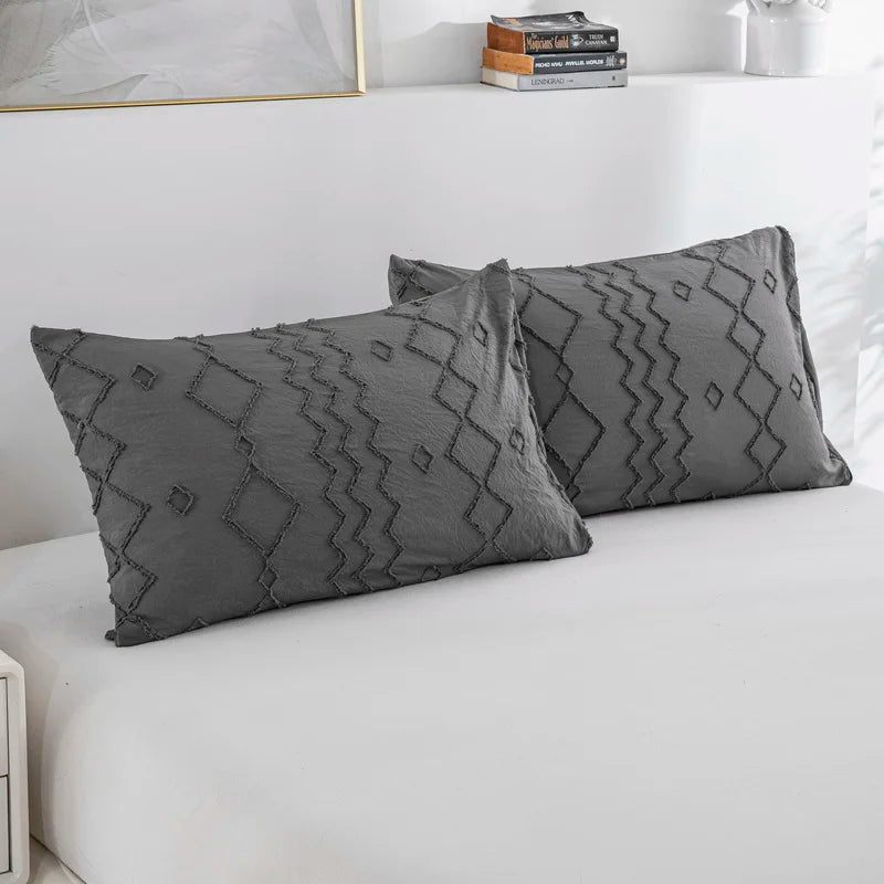 Nutshell tufted gray duvet cover set with textured geometric patterns on matching pillow shams