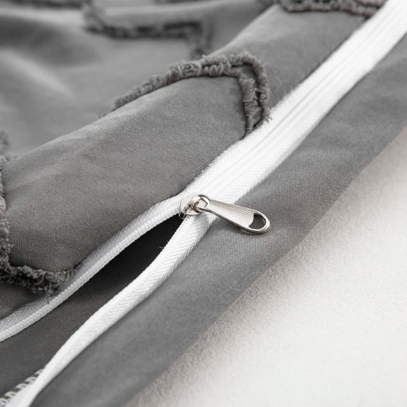 Close-up of zipper on tufted gray duvet cover set showing detailed stitching and texture by Nutshell