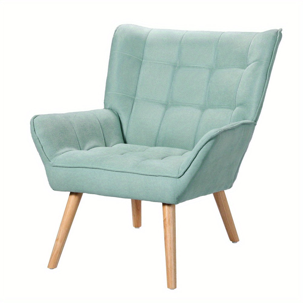 Nutshell Tufted Wingback Armchair in light green with wooden legs and plush upholstery