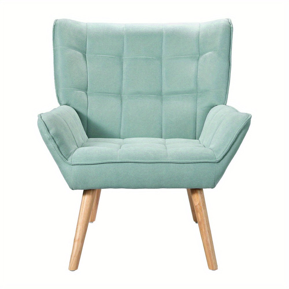 Nutshell Tufted Wingback Armchair in light green with wooden legs and padded upholstery