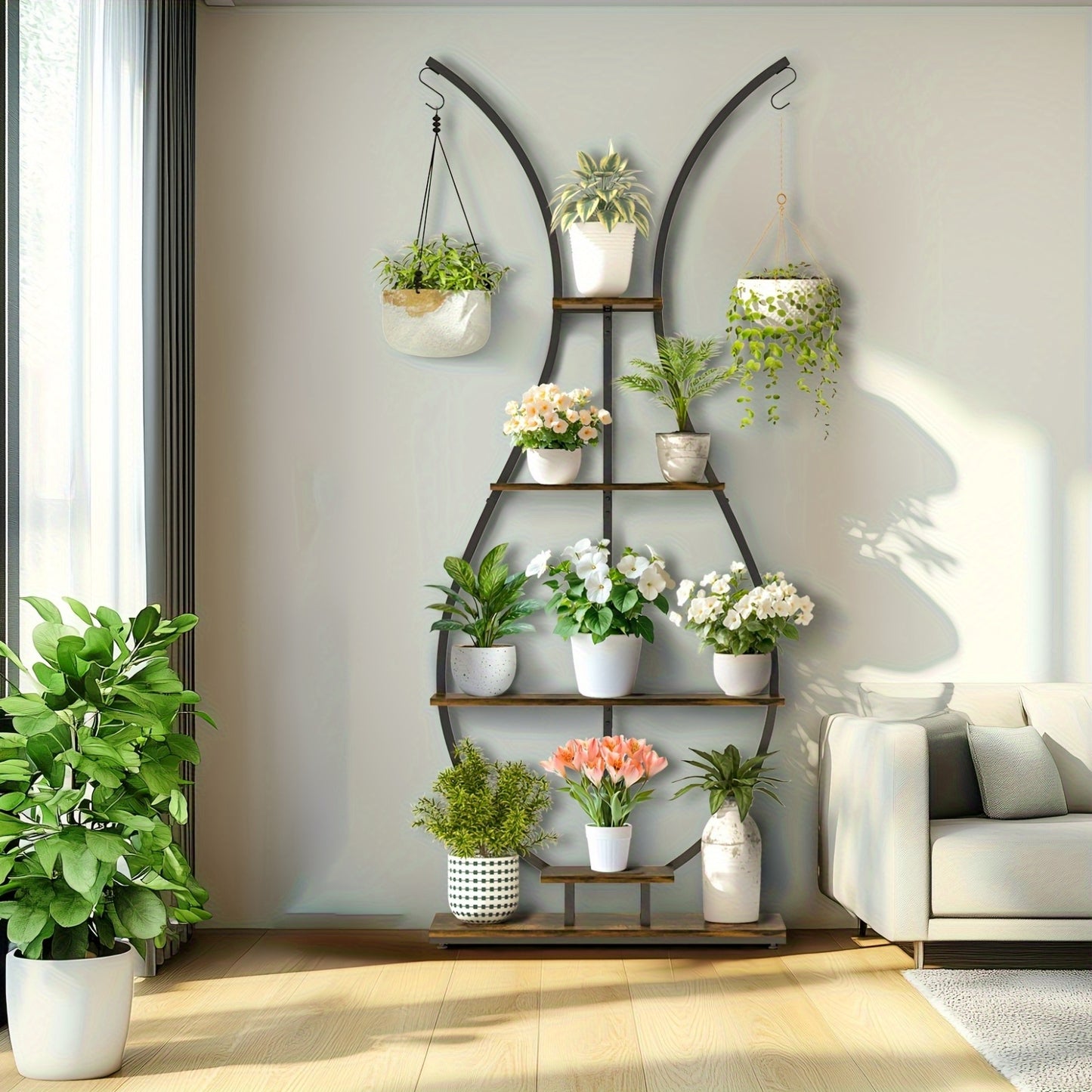 Vase-shape metal plant shelf with multiple tiers displaying various potted plants in a bright living room