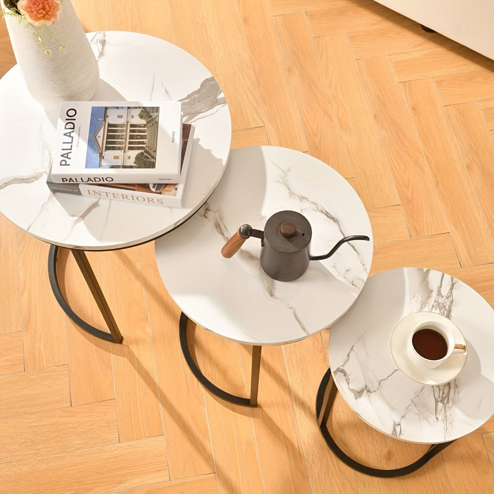 Nutshell modern side table set with white marble tops and black metal legs on wooden floor