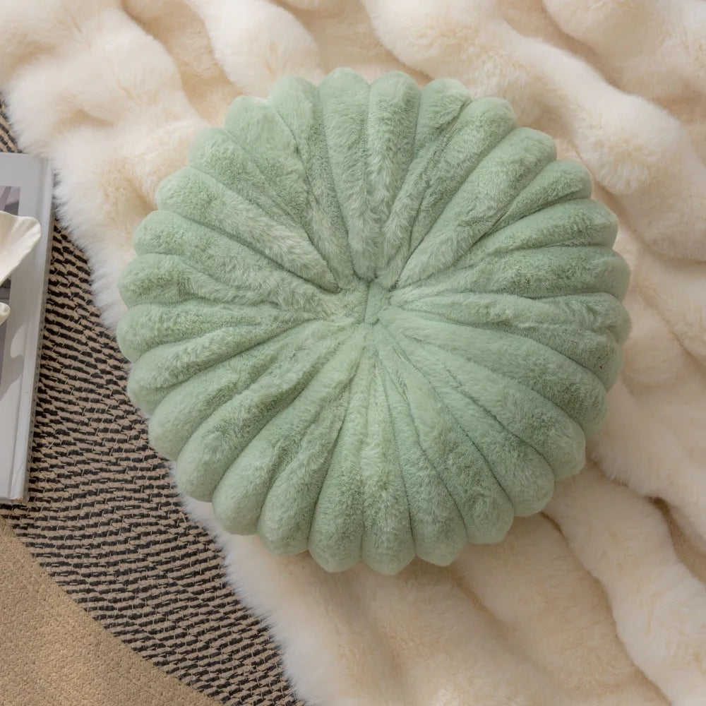 Nutshell green round pumpkin pillow cushion with soft plush texture on cozy rug