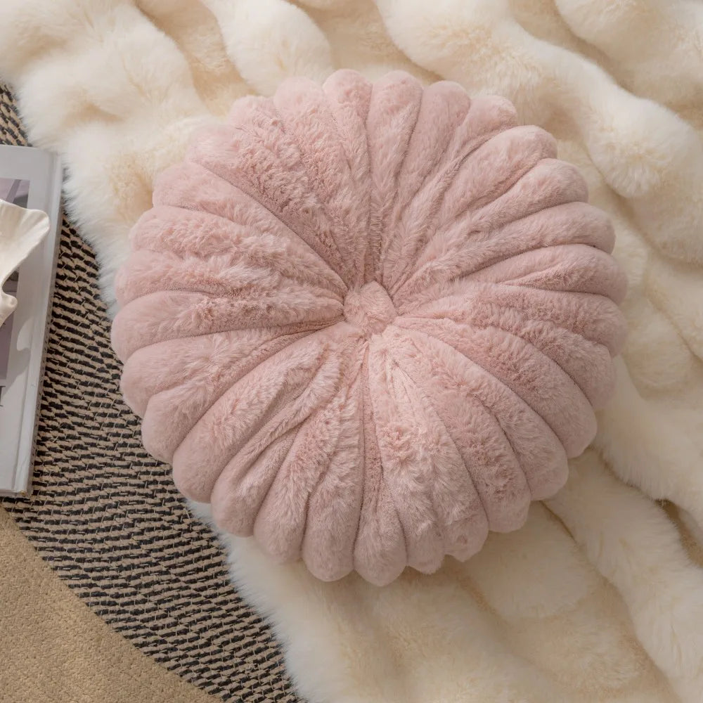 Nutshell soft pink round pumpkin pillow cushion with plush texture on cozy blankets