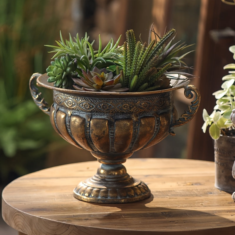 Nutshell vintage wrought iron pot vase with ornate handles filled with green succulent plants