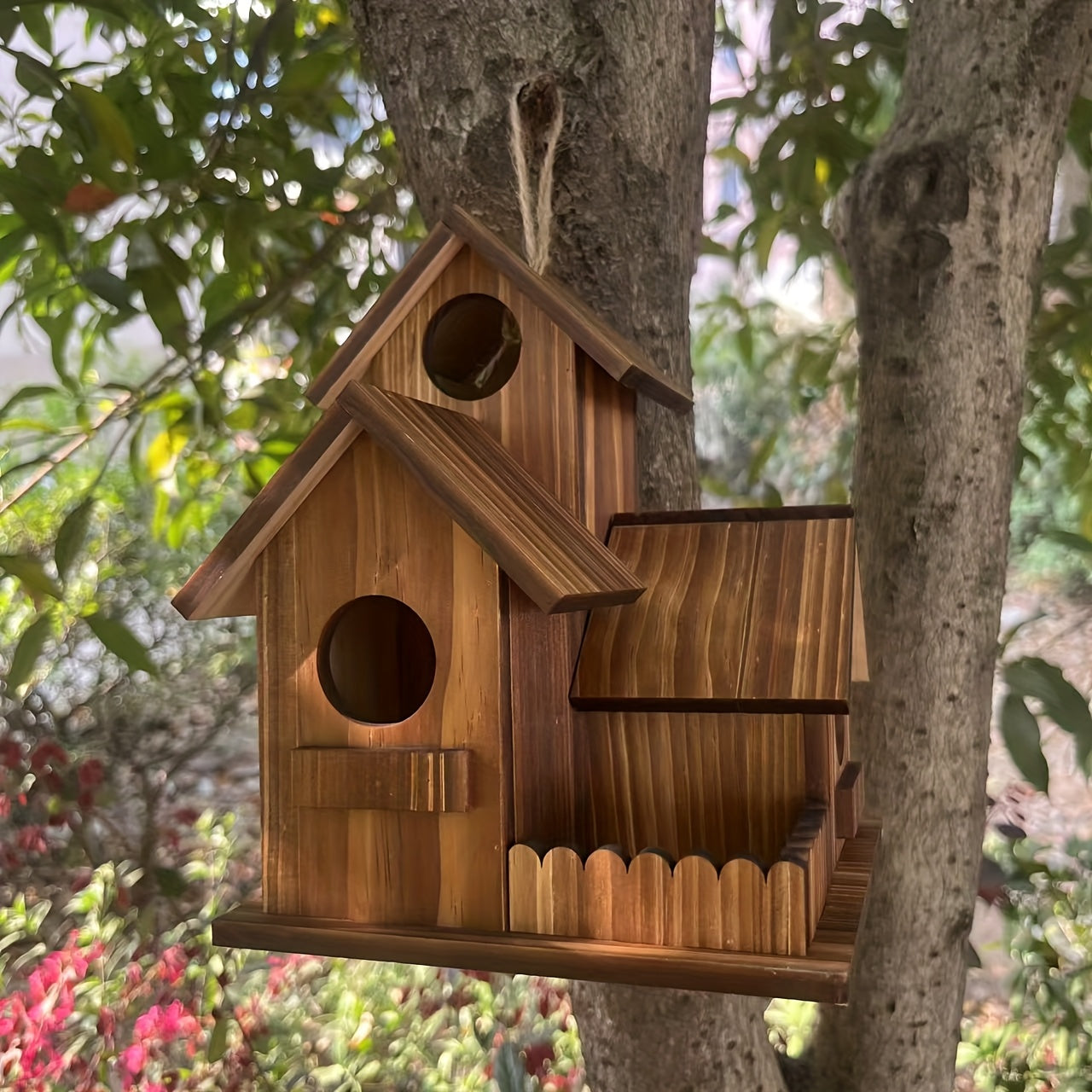 Nutshell Wooden Birdhouse hanging from a tree, featuring a charming design and natural wood finish
