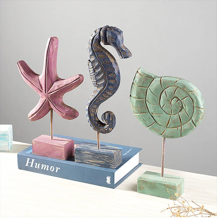 Wooden ocean theme decorations featuring starfish, seahorse, and shell ornaments on stands