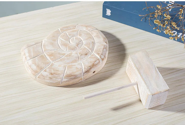 Nutshell wooden ocean theme decorations featuring a carved shell-shaped ornament and stand on light wood surface