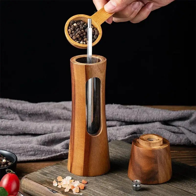 Nutshell wooden salt and pepper grinder set with clear window and natural wood finish in use