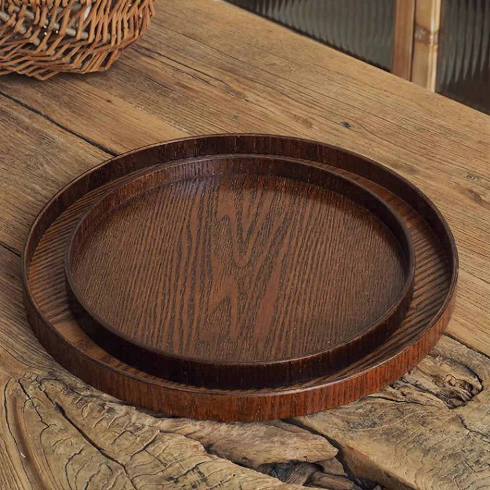 Nutshell wooden serving tray set with two round brown trays on rustic wooden table