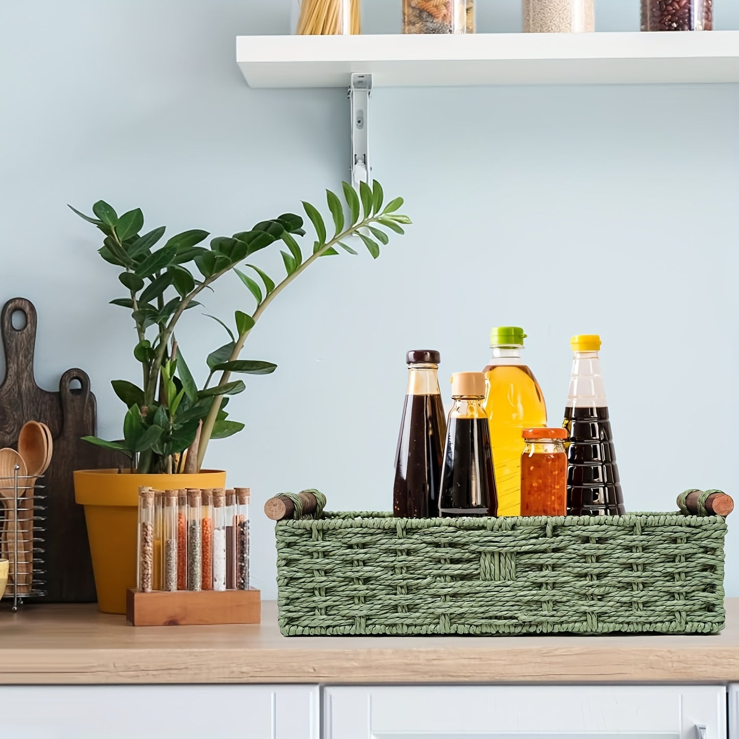 Nutshell woven storage basket holding various bottles on a kitchen countertop