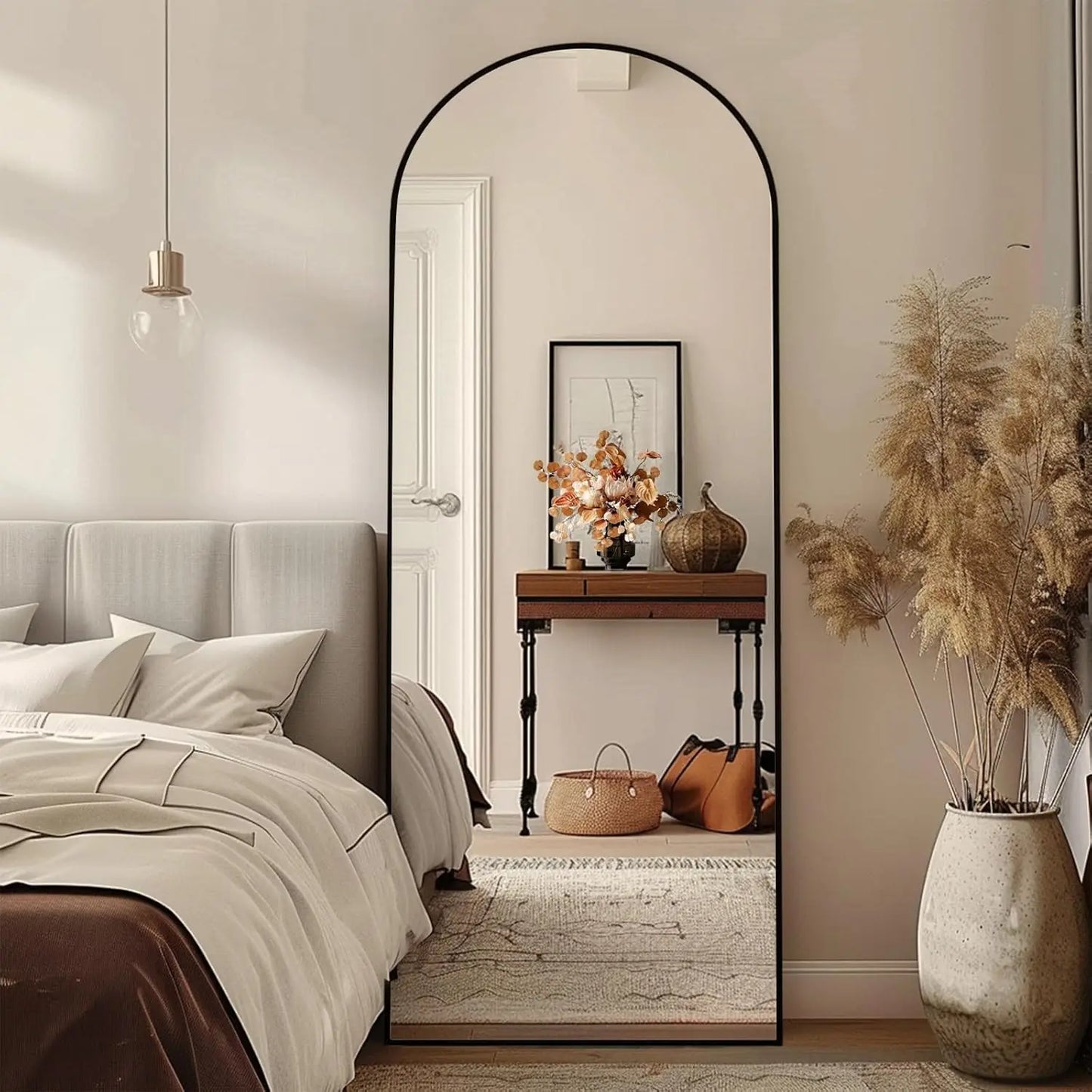 Nutshell arched full length floor mirror with slim black frame leaning in a modern bedroom