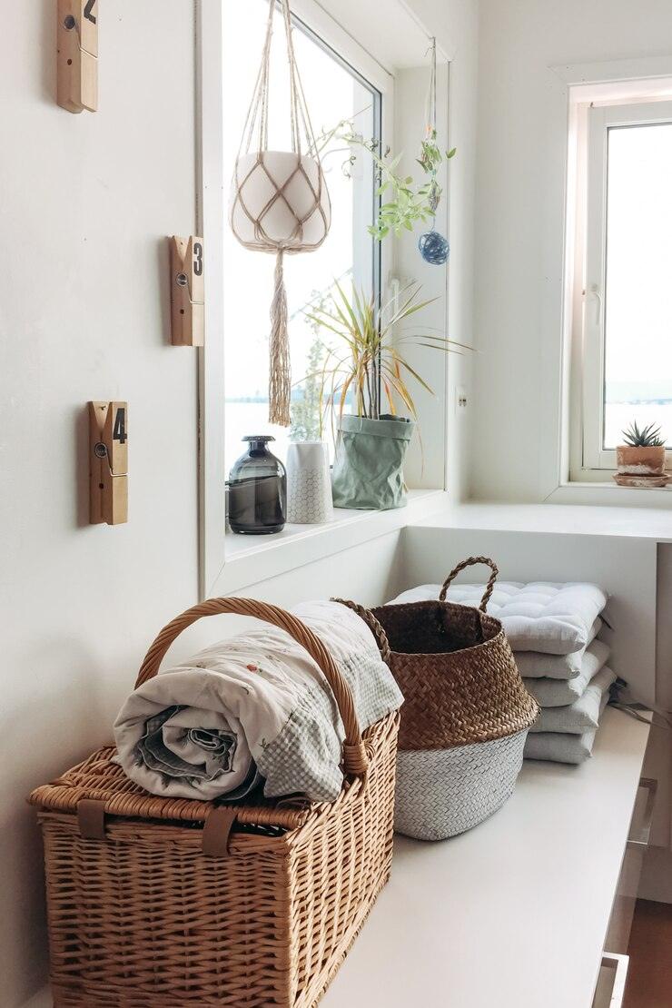 Bright laundry homewares collection featuring woven baskets, folded linens, and indoor plants in a cozy laundry space