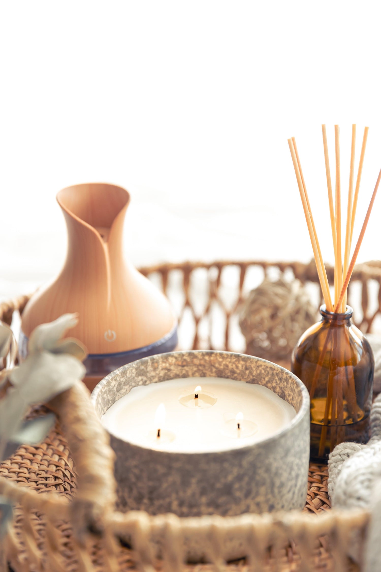 Aromatherapy collection featuring essential oil diffuser, candles, and reed diffusers for a calming atmosphere