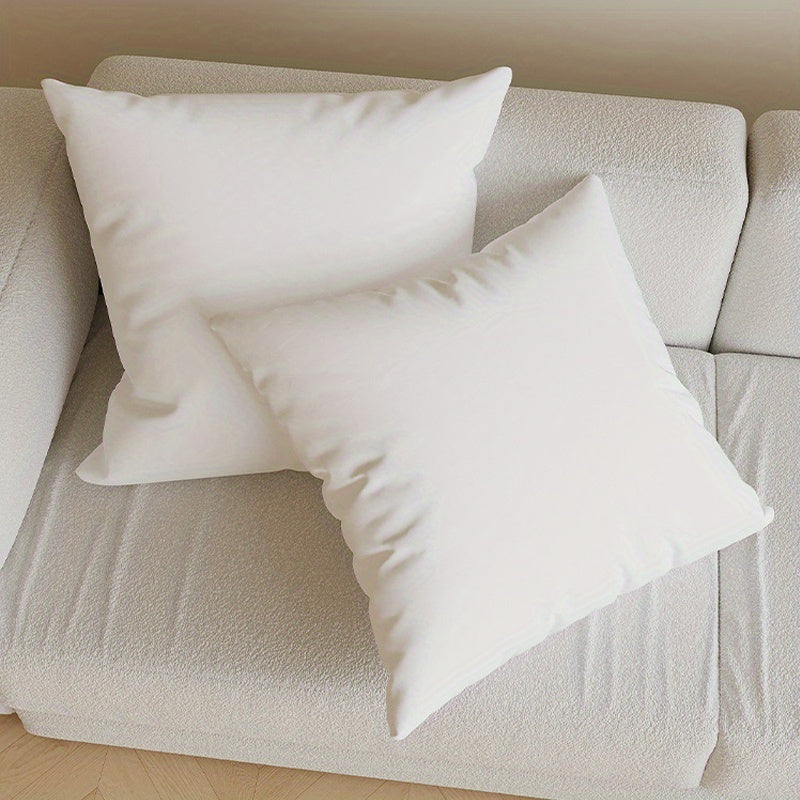 Two plush white 4pcs Throw Pillow Core on a light sofa for home decor and comfort