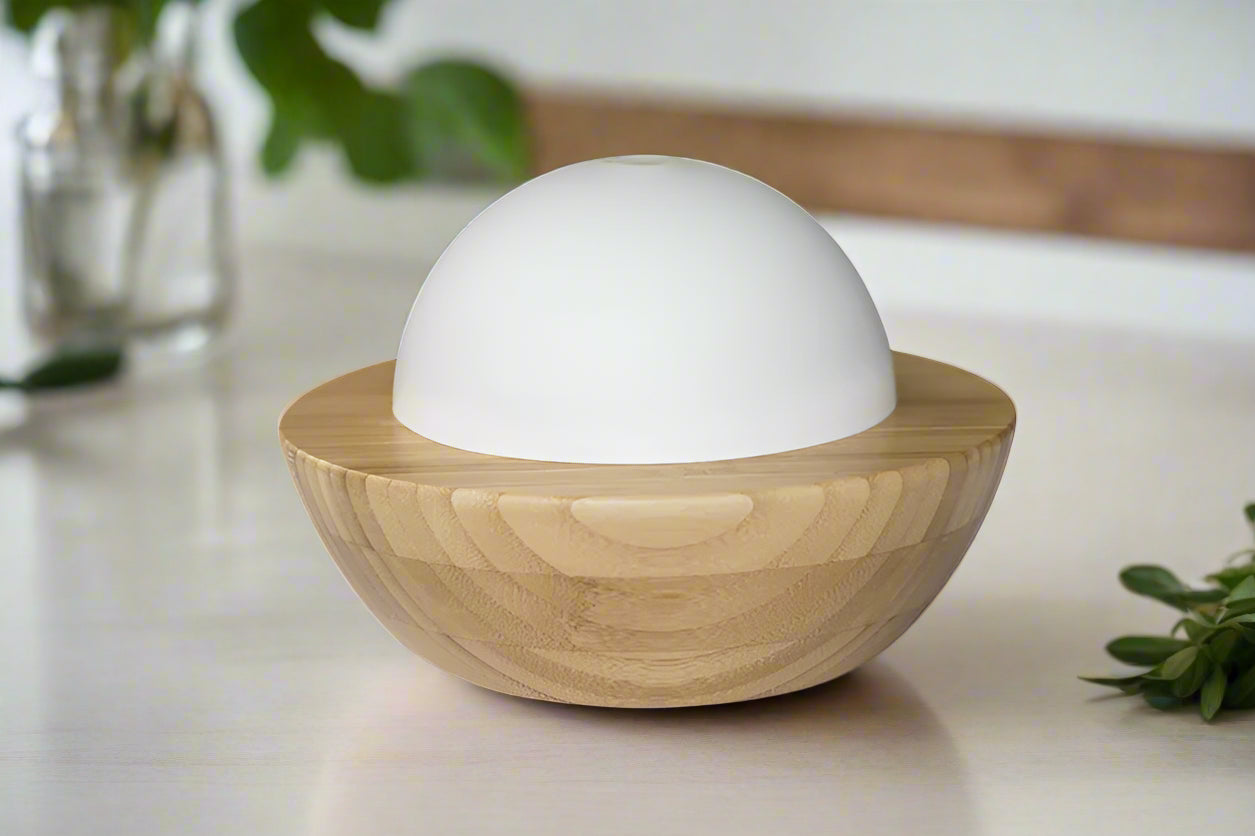 Nutshell bamboo essential oil diffuser with wooden base and white dome top for home aromatherapy