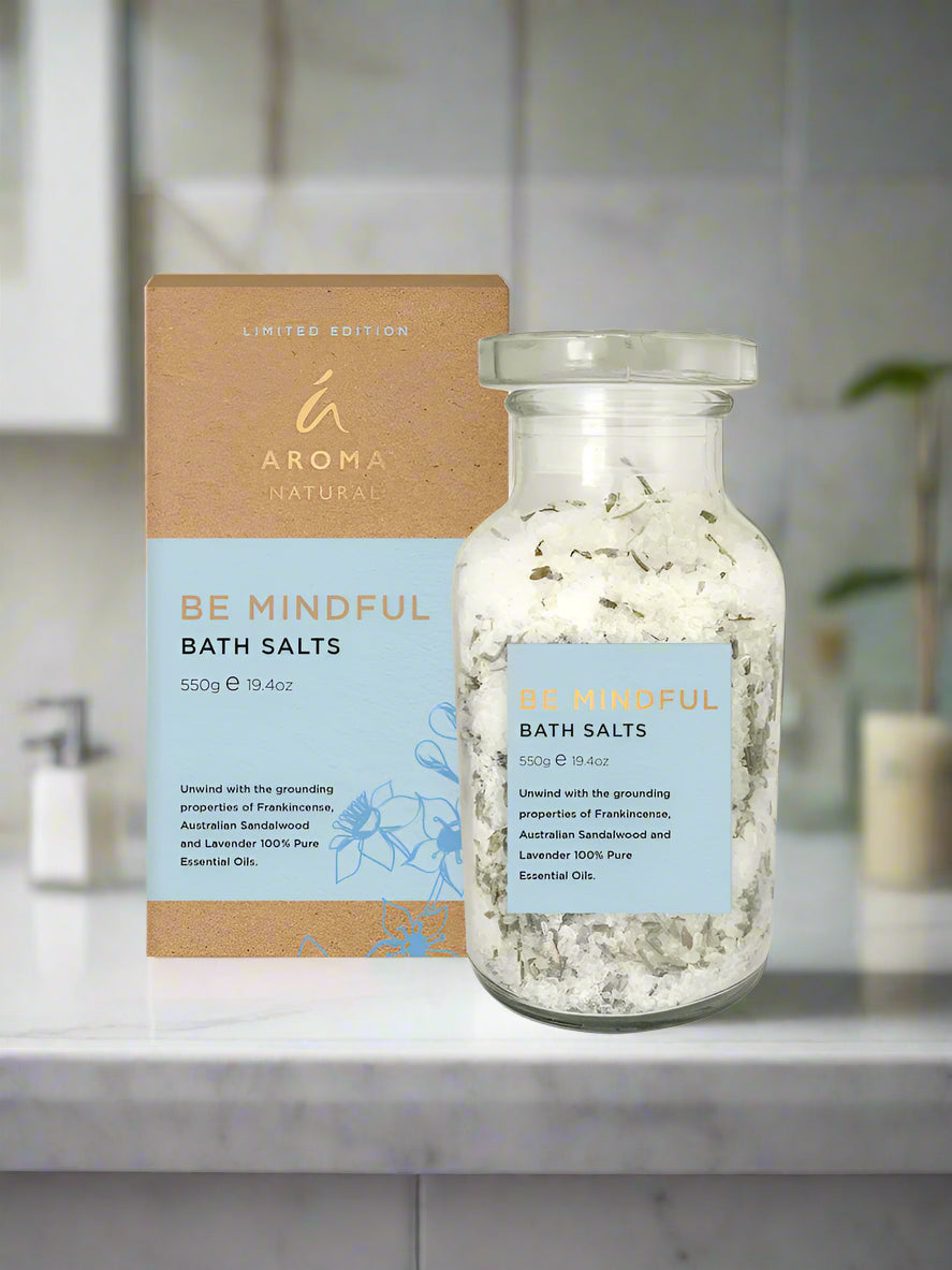 Be Mindful Bath Salts with Frankincense and Lavender in glass jar and packaging on bathroom counter