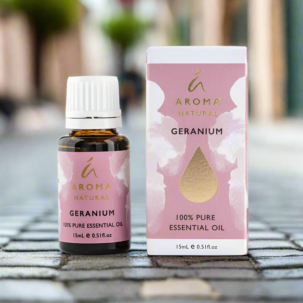 Nutshell Geranium Pure Essential Oil 15ml bottle and box with pink and gold label outdoors