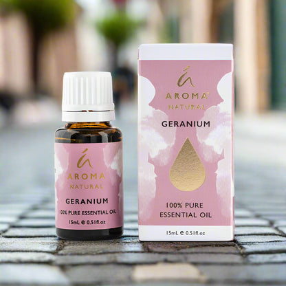 Nutshell Geranium Pure Essential Oil 15ml bottle and box with pink and gold label outdoors