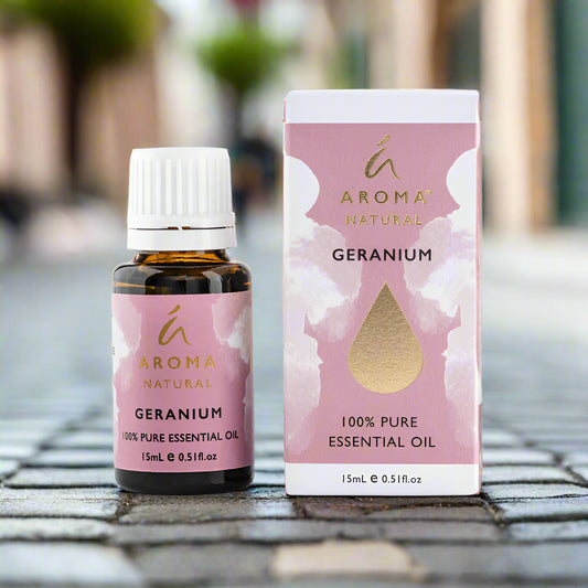 Nutshell Geranium Pure Essential Oil 15ml bottle and box with pink and gold label outdoors