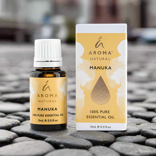Nutshell Manuka Essential Oil 15ml bottle and box with natural yellow design on cobblestone background
