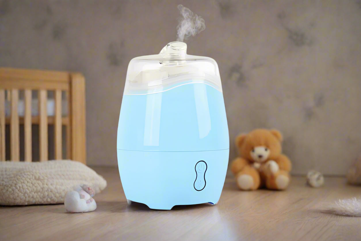 Nutshell Aroma Natural Vaporiser - Blue diffuser releasing mist on wooden surface with soft background
