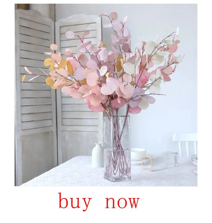 Artificial eucalyptus bouquet in soft pastel colors arranged in a clear vase for elegant decor