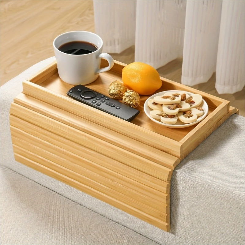 Bamboo Armrest Tray with a cup of coffee, snacks, and a remote on a cozy sofa
