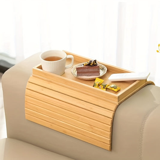 Nutshell Bamboo Armrest Tray on a sofa holding a cup of coffee and a dessert plate