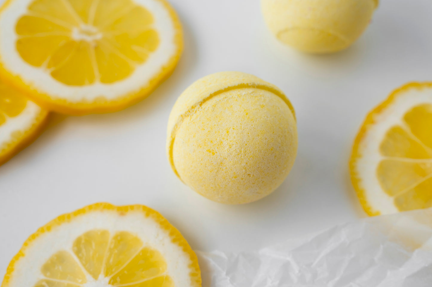 Nutshell Bath Fizz Bon Bon in Lemon Scent with Bright Yellow Color and Slices of Fresh Lemons