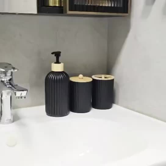 Nutshell Bathroom Dispenser Set featuring stylish ribbed design in black and beige colors