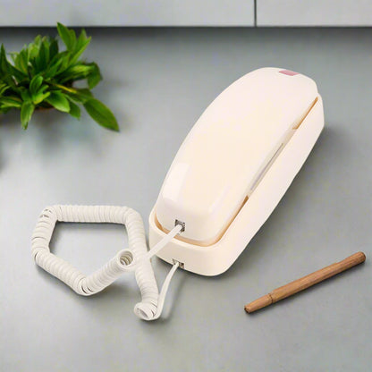Nutshell Big Button Landline Wall Phone in white with a coiled cord for easy access